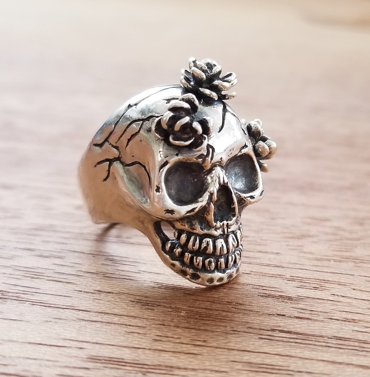 Silver skull ring with three flowers, handmade and substantial.